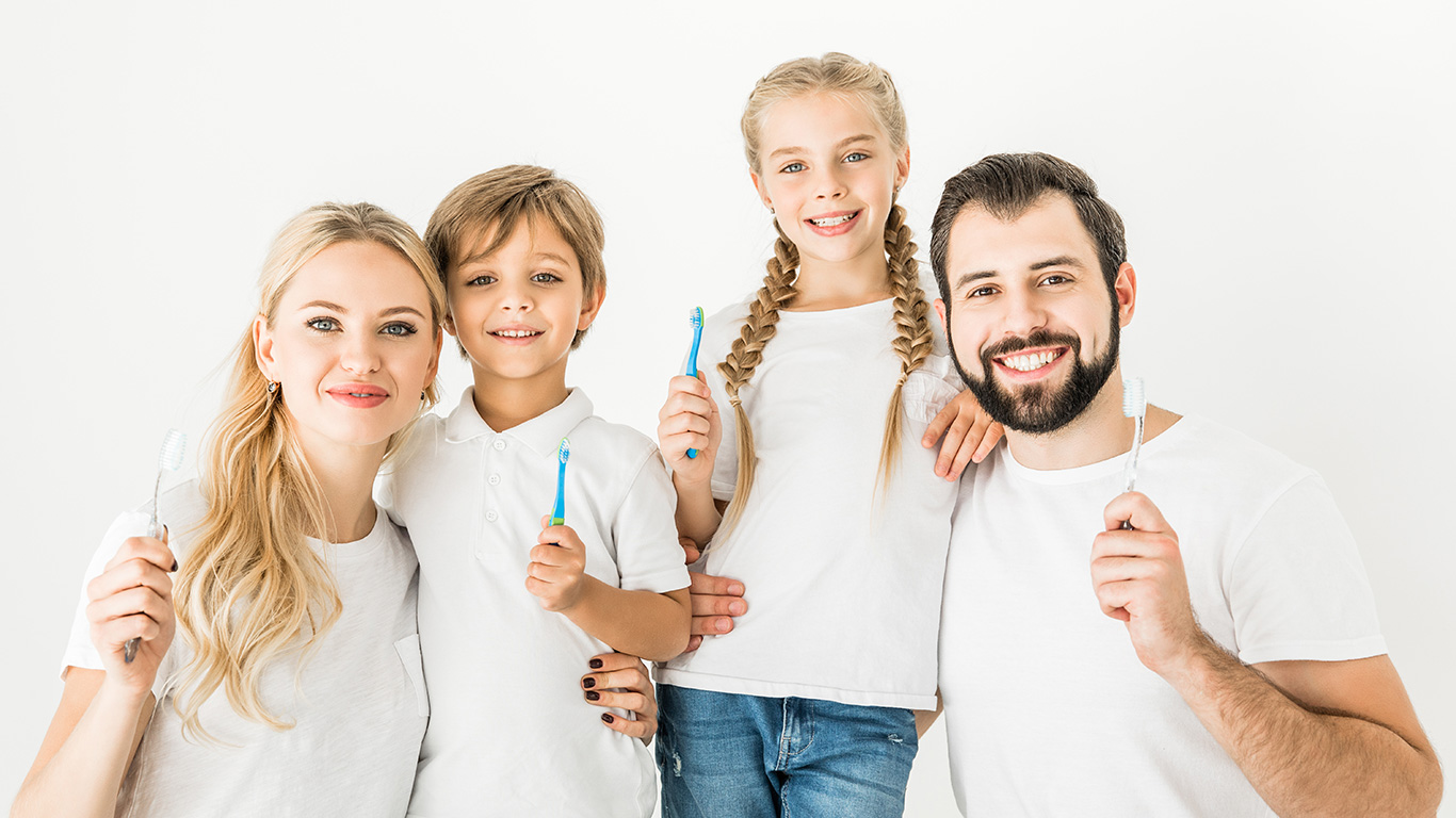 Happy smiling family with toothbrushes