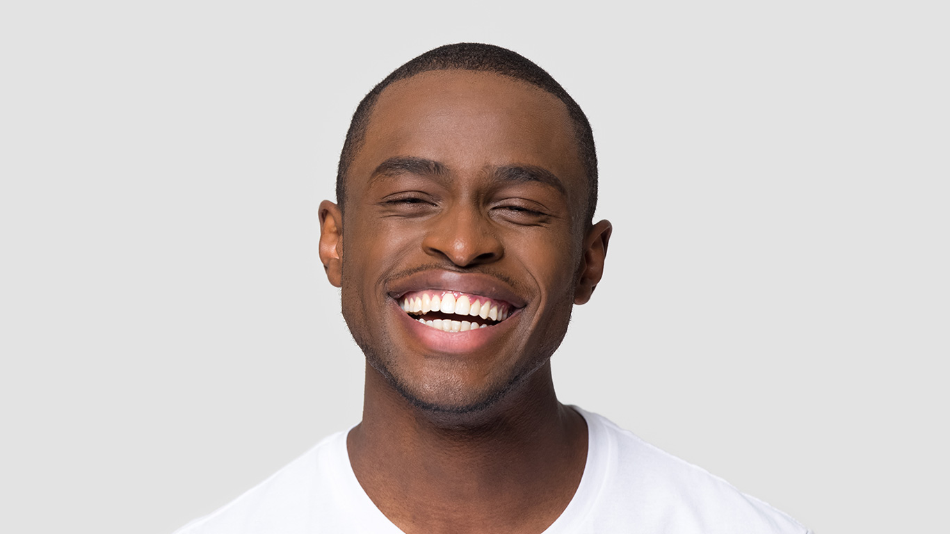 Young man smiling big with straight teeth